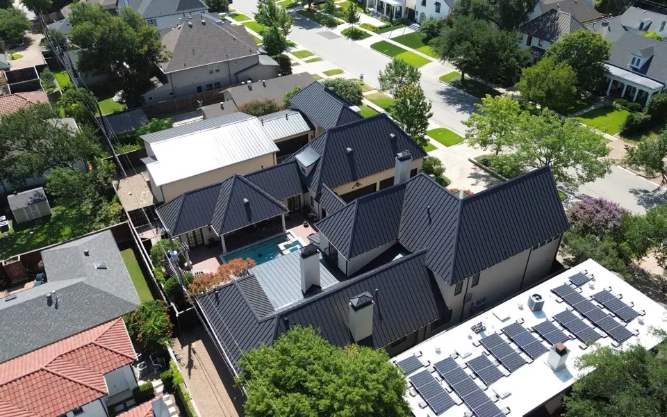 Overhead view of a finished charcoal shingle roof with crisp ridge lines and valleys